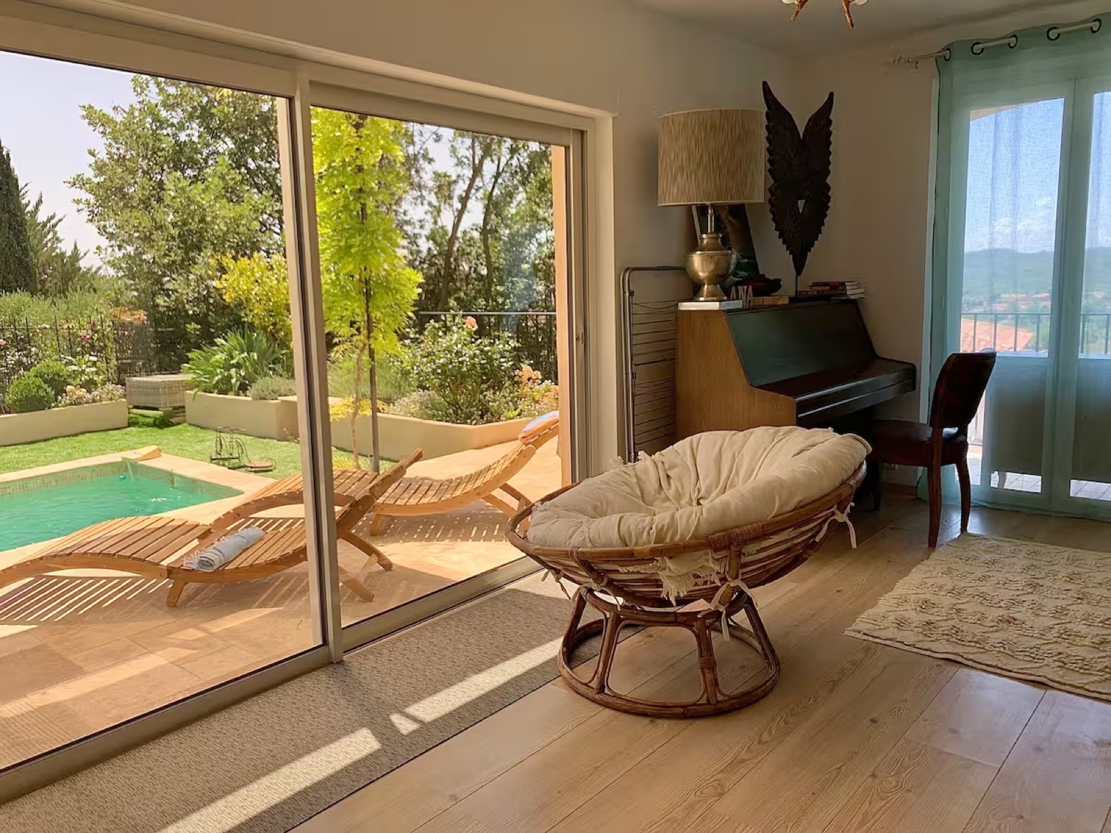 Garden room papasan chair overlooking pool